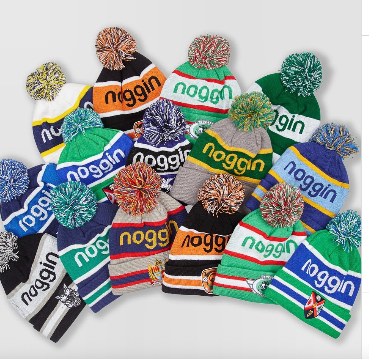 A colorful collection of custom Noggin pom-pom beanies